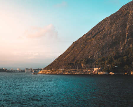 A scenery of a rock formation at the ocean shore in Rio de Janeiroの写真素材