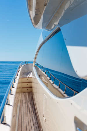 A vertical shot from the yacht of the sea and a blue sky at daytime