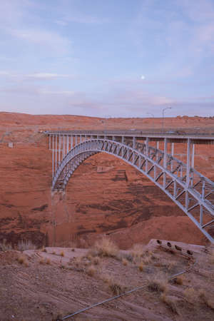 A vertical scenic shot of Glen Canyon Dam Bridge during daytimeの写真素材