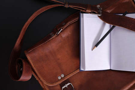 Old fashion leather briefcase on black background