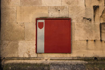 A closeup shot of a red and grey square on a building perfect for a neutral background
