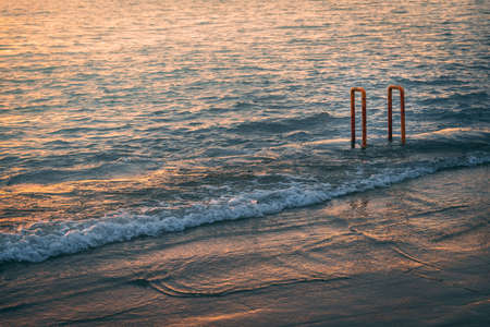 A beautiful scenery of the sunset reflection on the sea waves - great for a cool backgroundの写真素材