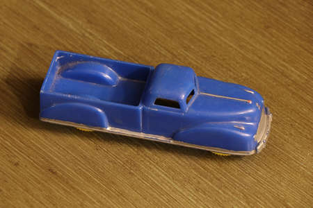 A high angle closeup of a blue car toy on a wooden surfaceの写真素材
