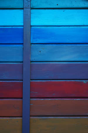 A vertical shot of a wooden wall with different colorsの写真素材