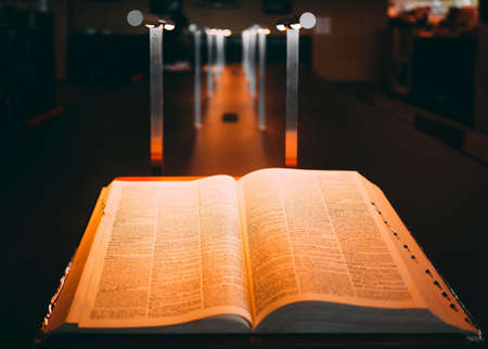 An open book on a long table.の写真素材