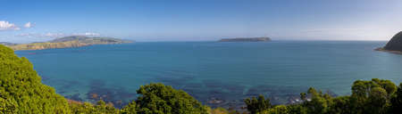 A panoramic shot of the ocean and the mountains captured in the suburbs of Wellington, New Zealandの写真素材
