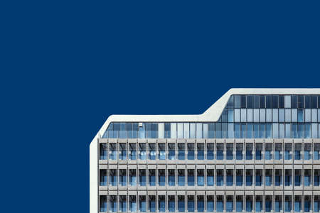 A low angle shot of a beautiful glass building under the blue skyの写真素材