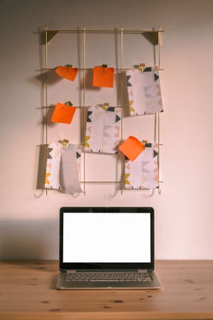 A vertical shot of wooden surface with a laptop with mockup empty screen with copy space for contentの写真素材