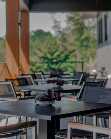 A vertical shot of neat tables in a nice, empty and clean restaurantの写真素材