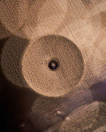 Photos created by adding drops of oil into water and then creating some texture using different...