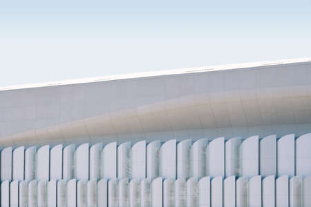 A low angle shot of a white concrete building under the bright sky