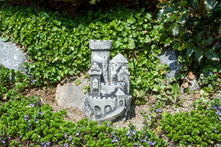 A little stone castle surrounded by greenery in a park under sunlight in Croatiaの写真素材