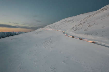 A high angle shot of a snowy frozen convoy towards the Nordkapp, Norway