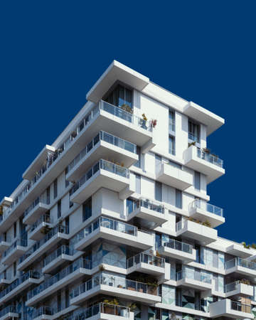 A low angle shot of a white concrete building under the clear blue sky
