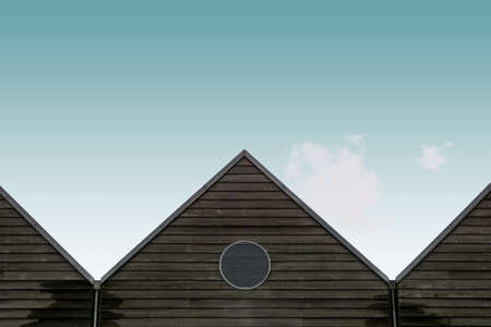 A low angle shot of the wooden brown houses under the blue skyの写真素材