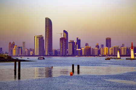 The city of Dubai at sunset and a lake with its beautiful skyscrapers in the backgroundのeditorial素材