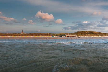 A high angle shot of the sea and the beach under the beautiful sky captured in Domburg, Netherlandsのeditorial素材