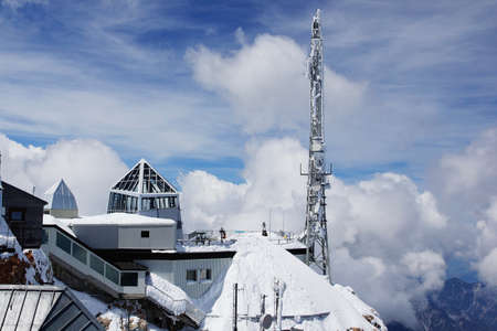 An amazing shot of a weather station on top of a mountain surrounded by a sea of clouds in winterのeditorial素材