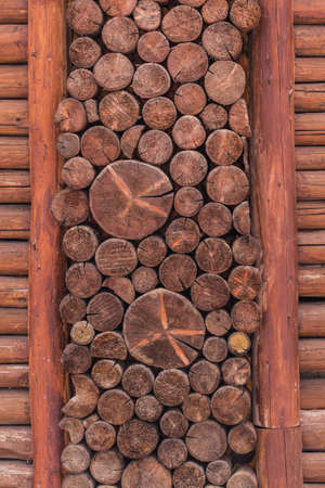 A closeup of round brown logs stacked on each other - a cool picture for wallpapers and backgrounds