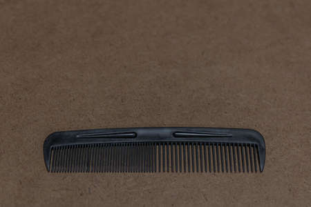 A closeup shot of a hair comb on a brown surface
