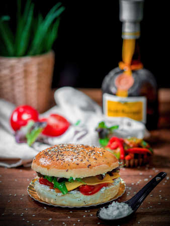 A vertical shot of a delicious hamburger on a wooden table