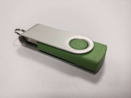 A green USB flash drive on a white background