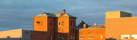 A panoramic shot of buildings with a blue sky in the background at daytimeの写真素材