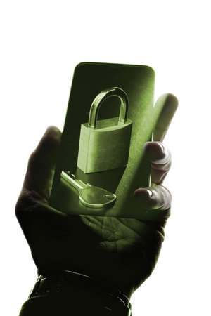 A cool photo of a person holding a mobile device with a lock and a key depicted on it - security and protection conceptの写真素材