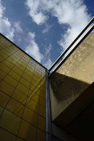 AMSTERDAM, NETHERLANDS - Mar 09, 2019: A low angle view of a modern building with yellow walls near a metro station in Amsterdamのeditorial素材