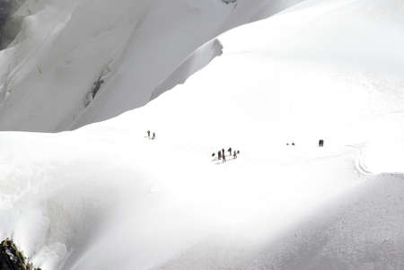 A high angle shot of mountaineers on the slopes of the Mont Blanc