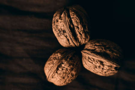 A closeup selective focus shot of delicious fresh walnuts on a wooden surfaceの写真素材