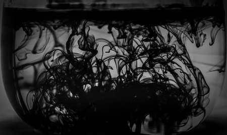 A greyscale shot of beautiful patterns formed from the black smokeの写真素材