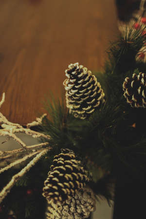 A vertical shot of acorns on fir leaves spreading a festive cheerful atmosphereの写真素材