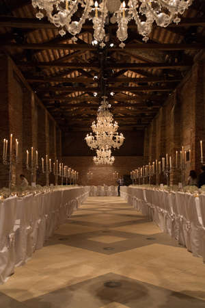 A vertical shot of a wedding venue with beautiful chandeliers