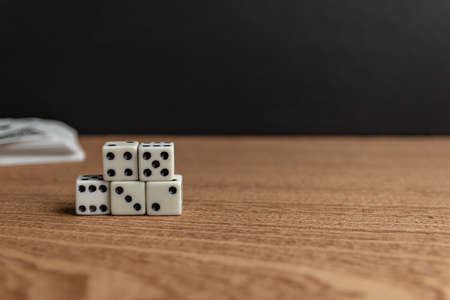 A selective focus shot of dices on a wooden surfaceの写真素材