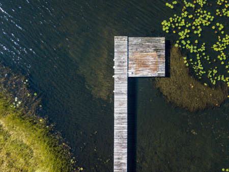 An aerial shot of a wooden pathway over the water at day timeの写真素材