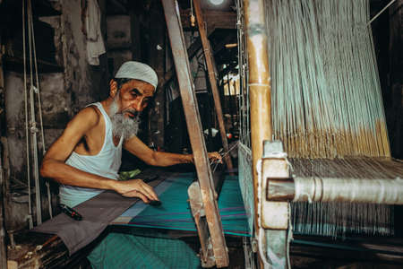 VARANASI, INDIA - Aug 12, 2018: Indian muslim making handmade clothes in Varanasi, Indiaのeditorial素材