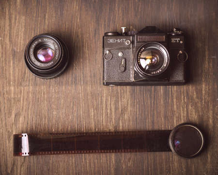 old camera,lens and film on a wooden surfaceの写真素材