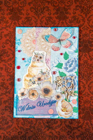 A vertical high angle shot of an amazing handmade post card on a beautiful surfaceの写真素材