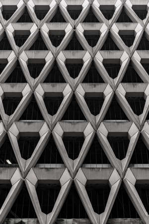 A greyscale of modern architecture with metallic walls under the lightsの写真素材