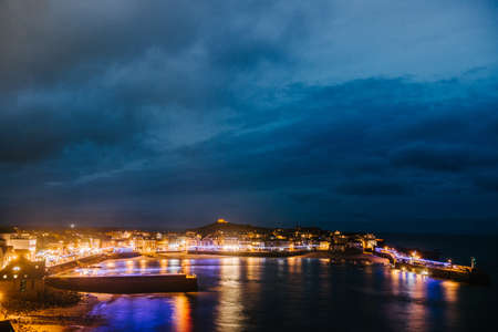 Christmas time in St Ives, Cornwall, UK. You can see the lights displayed in the seaside fishing village with empty cobbled streets.の写真素材