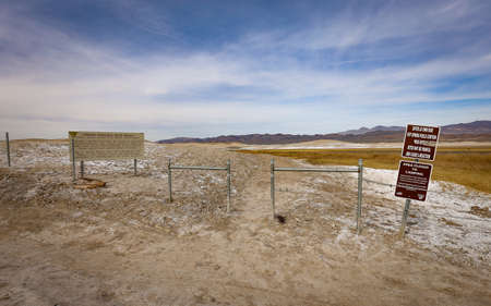 TECOPA, CALIFORNIA, UNITED STATES - Apr 19, 2018: The entrance gate to a natural hot springs pool in the Mojave Desert amidst a beautiful landscape in Tecopa, California.のeditorial素材