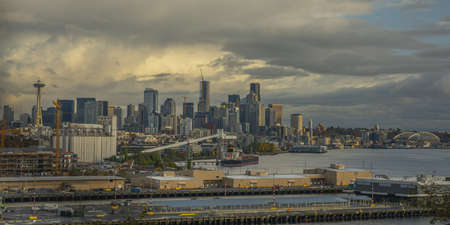 A wide high angle shot of the Seattle buildings with a cloudy sky in the background
