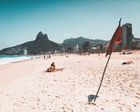 RIO DE JANEIRO, BRAZIL - Jan 07, 2020: Two girls having fun at the sand of Ipanema beach.