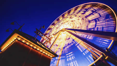 A low angle shot of a Ferris wheel on Chicago Navy Pier during the evening timeのeditorial素材