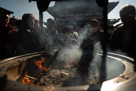 TOKYO, JAPAN - Jan 19, 2020: A crowd prays at the Jokoro in front of Senso-ji temple in Asakusa, Japan.のeditorial素材
