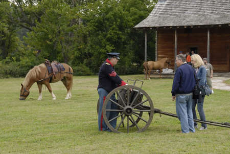 DEFIANCE, UNITED STATES - Sep 16, 2008: a participant showing a cannon to visitors at the Daniel...