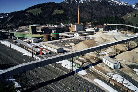 A high angle shot of a railway with shadows of trees below
