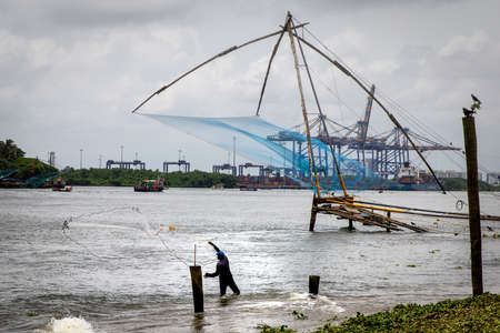 KOCHI, INDIA - Aug 03, 2018: Fishing in Kerala, India. These large fishing nets are called Chinese Fishing Nets and is a popular tourist attraction.のeditorial素材