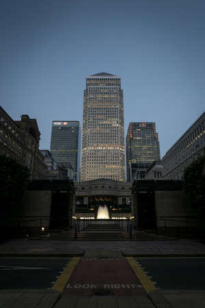 LONDON, UNITED KINGDOM - Jun 01, 2018: Canary Wharf towers at dusk with fountainのeditorial素材